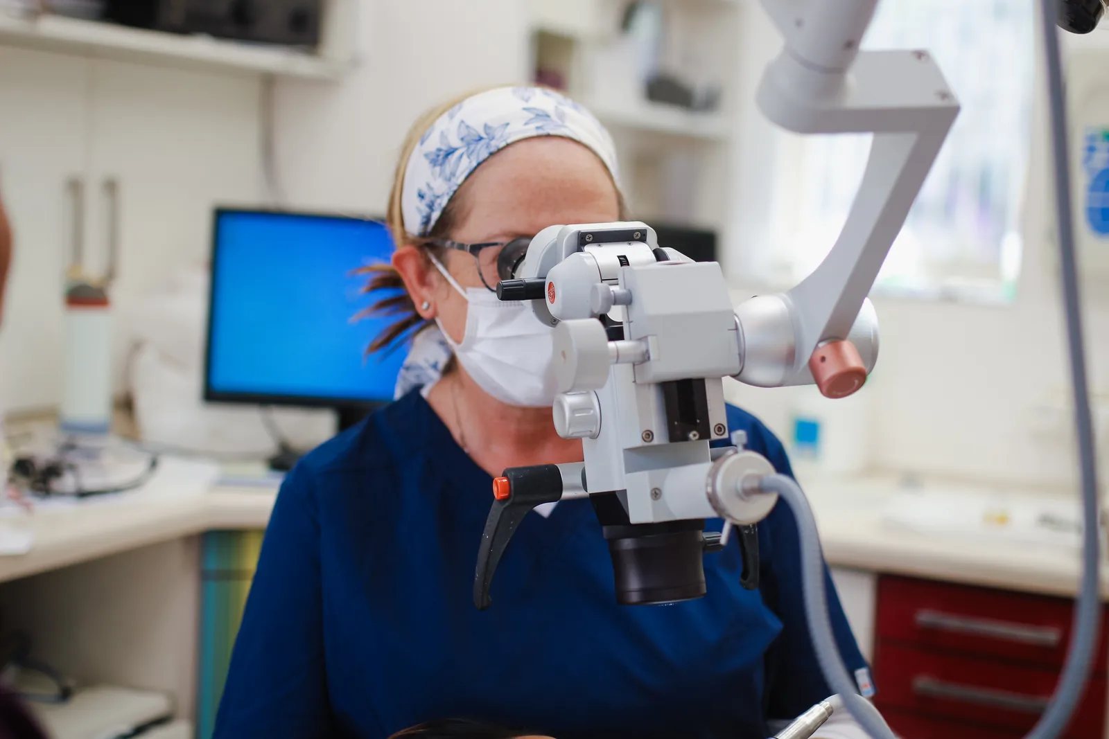 Dr. Tammy Silva using a dental microscope at K&J Dental Office
